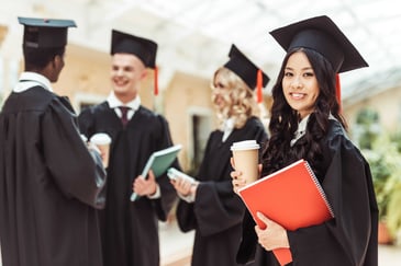 University graduates in caps and gowns representing graduate retention and clear career pathways beyond the graduate programme. 