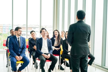 Business leaders engaged in a group coaching session representing how to measure executive coaching ROI and leadership outcomes. 