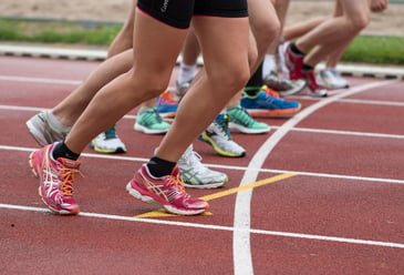 People lined up ready for a healthy running race to promote collaboration instead of having internal competition in the workplace which can destroy their team collaboration.  