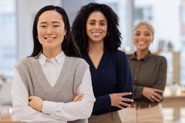 Young professionals collaborating in an office representing graduate development programmes and early career leadership training. 