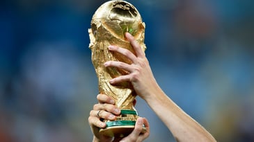 Someone lifting the world cup representing high-performing and resilient teams 