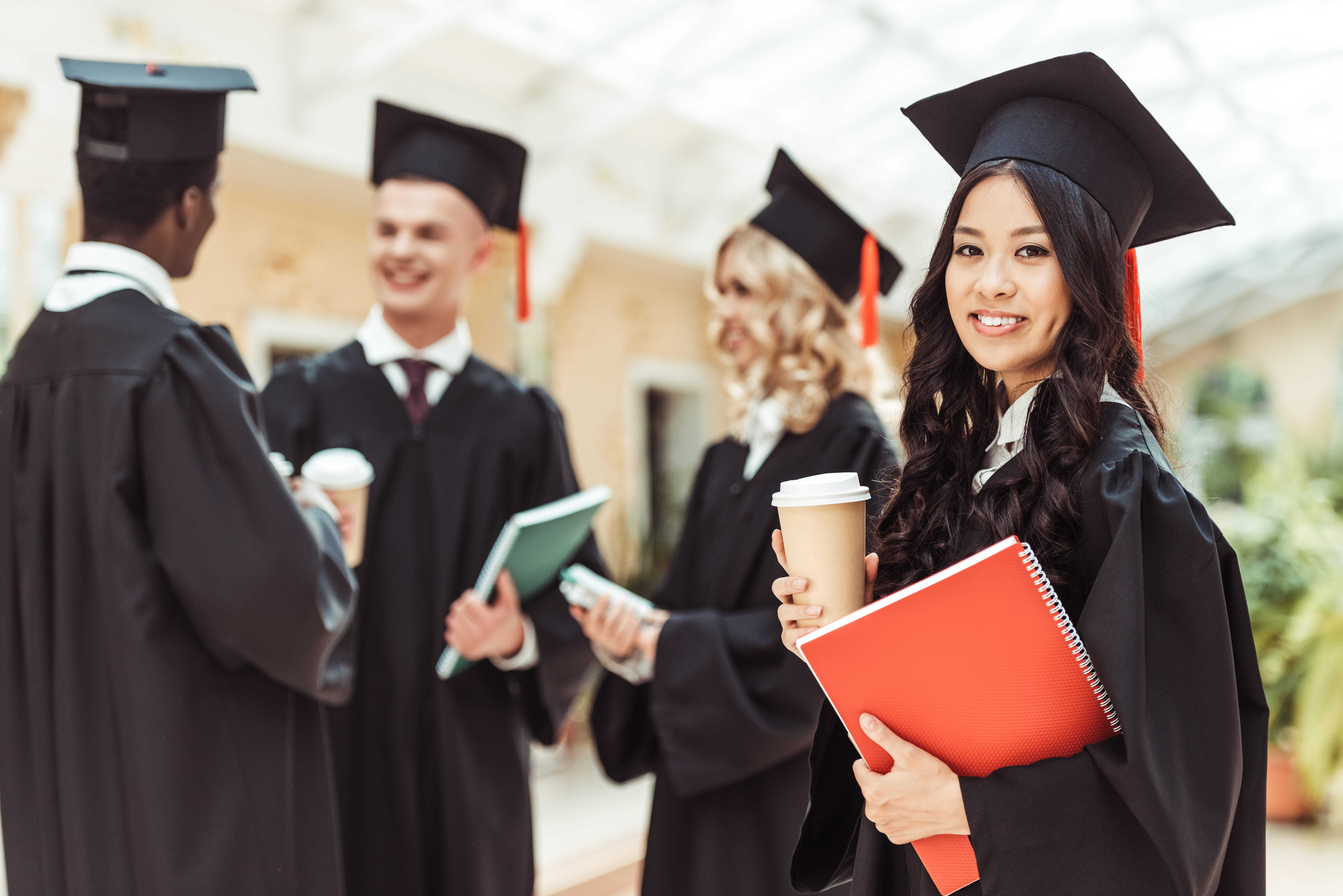 University graduates in caps and gowns representing graduate retention and clear career pathways beyond the graduate programme.