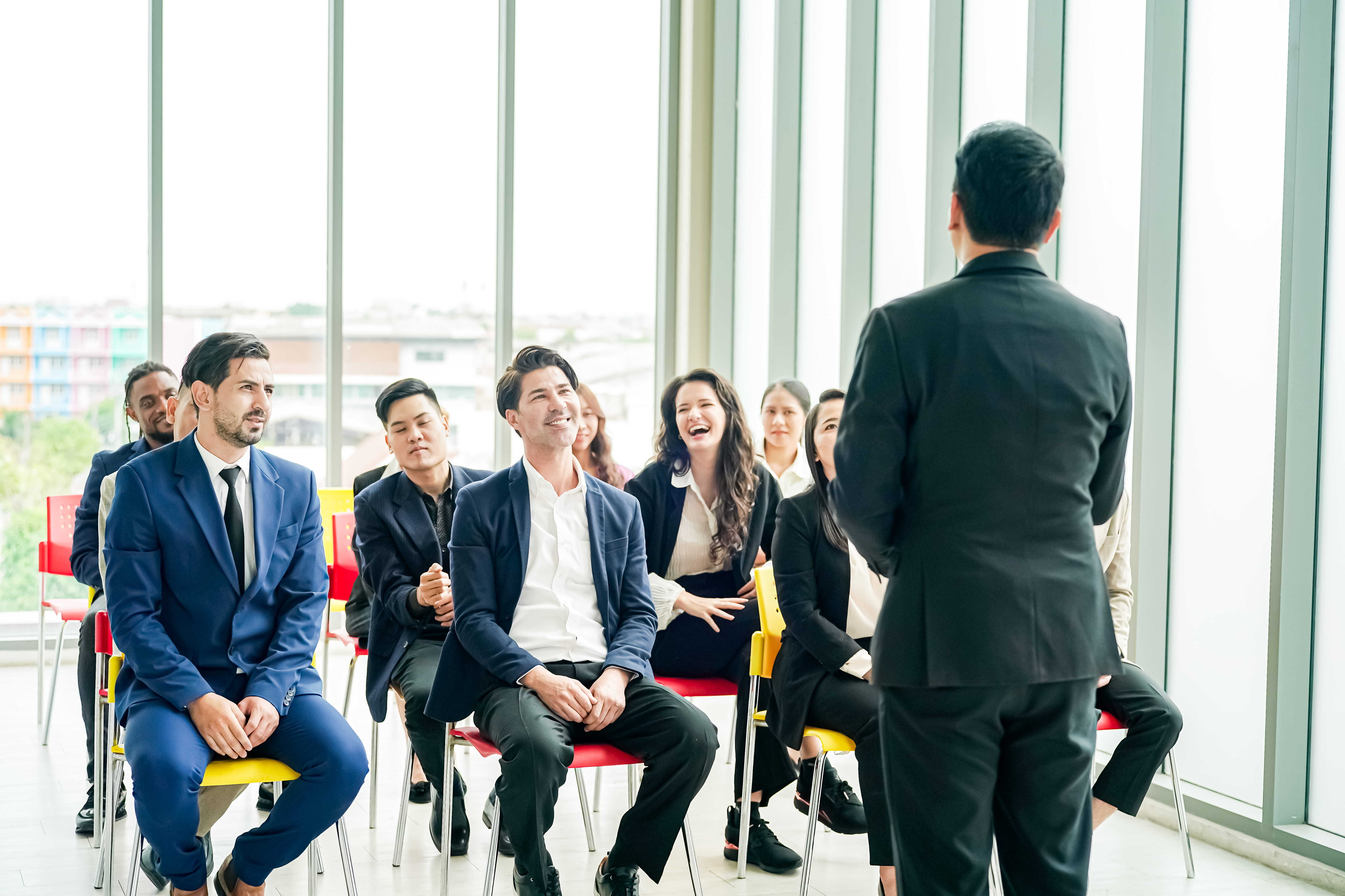 Business leaders engaged in a group coaching session representing how to measure executive coaching ROI and leadership outcomes.