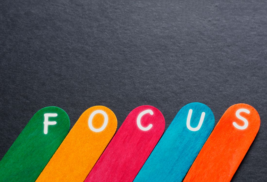 The word FOCUS spelt out on popsicle sticks by a business person who is struggling to stay focused on what they really want to do. 