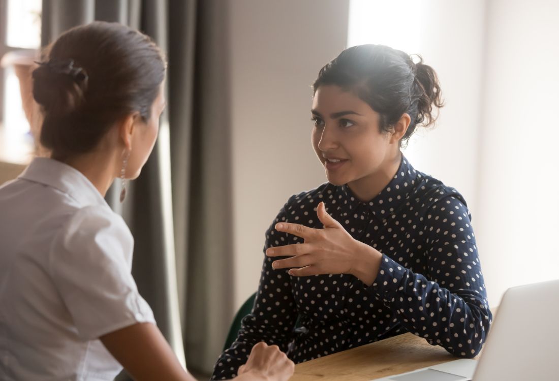 Two colleagues having a difficult conversation effectively as they listen to each other with open minds and understanding.