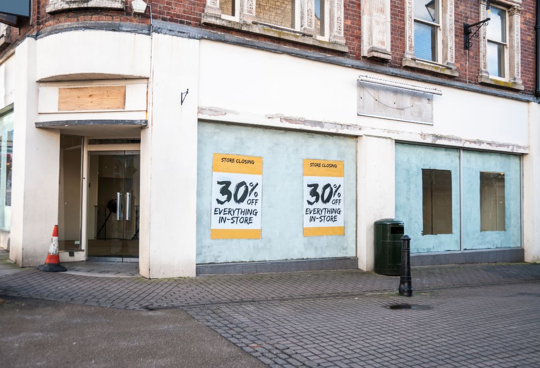 A front of a retail store on the high street which has closed down due to their business going bust after refusing to change with the times. 