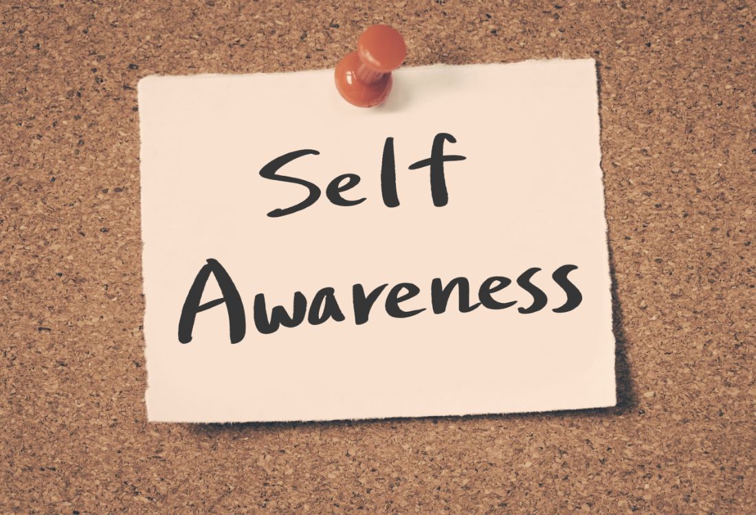 The words Self Awareness written on a piece of paper and pinned to a cork board by a business owner as they upskill this soft skill to better their role in leadership.
